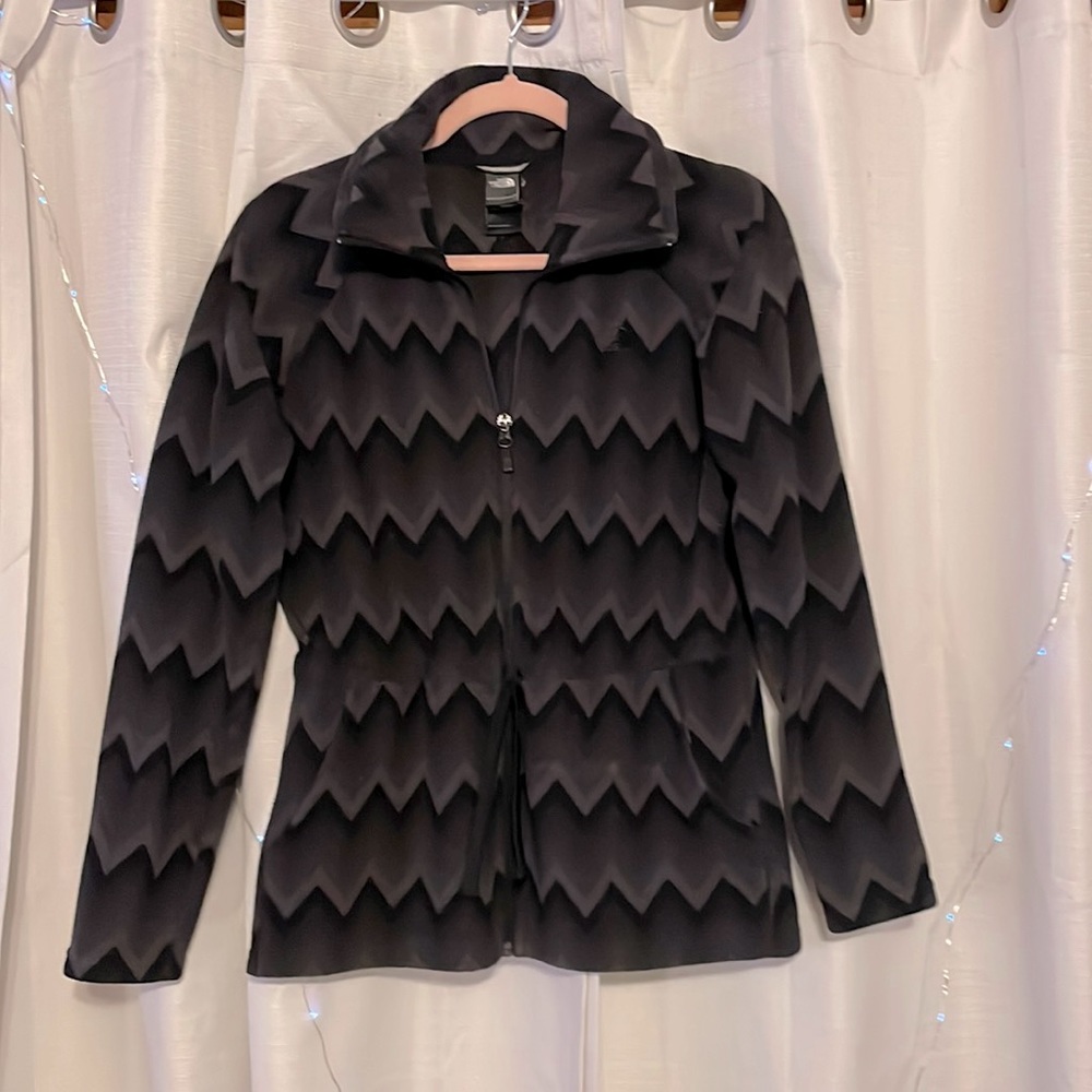 The North Face fleece jacket. Size M. Black and Gray zig zag pattern.